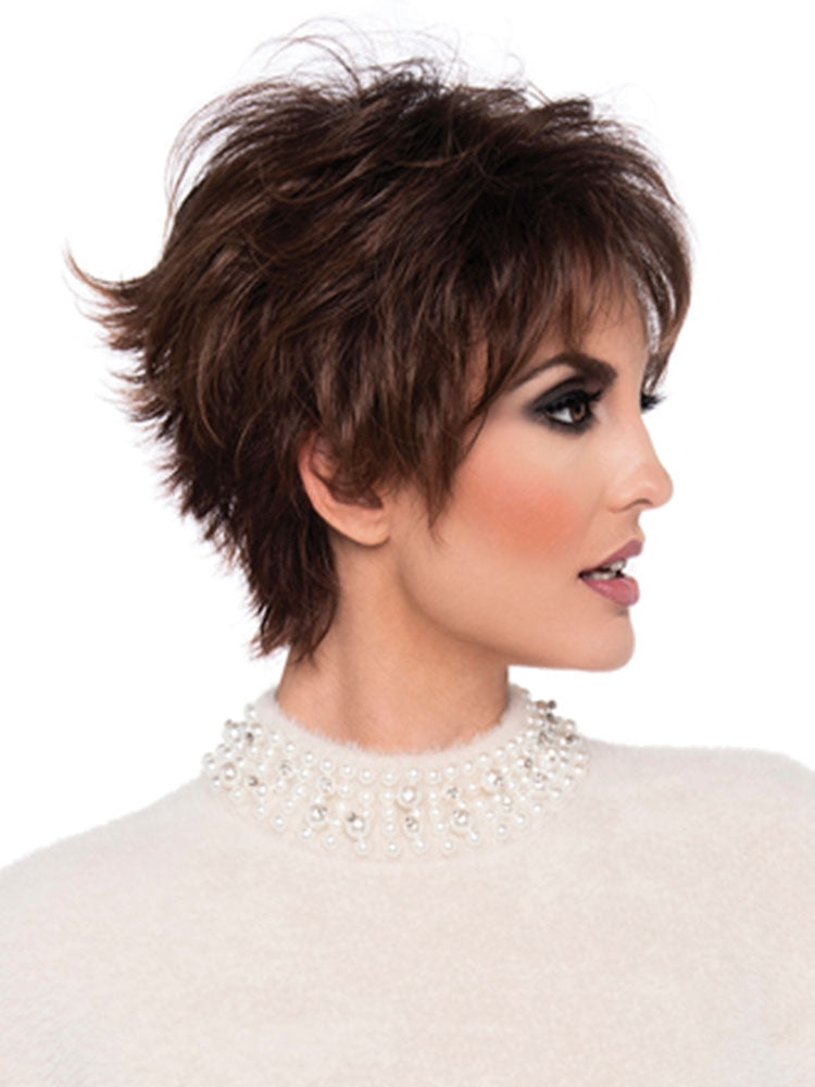 A woman wearing a chin-length, textured wig with a side part in a cinnamon raisin color, from the Envy Collection.