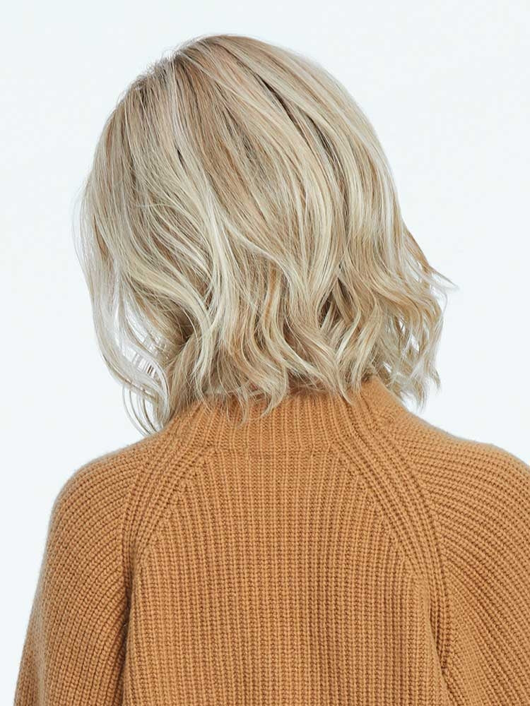 Back view of Simmer wig by Raquel Welch in Shaded Biscuit – beachy waves in a heat-friendly synthetic style.