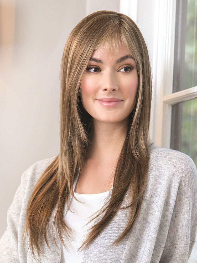 The Stevie wig by Amore in colour Honey Wheat has long flowing layers and monofilament top cap.