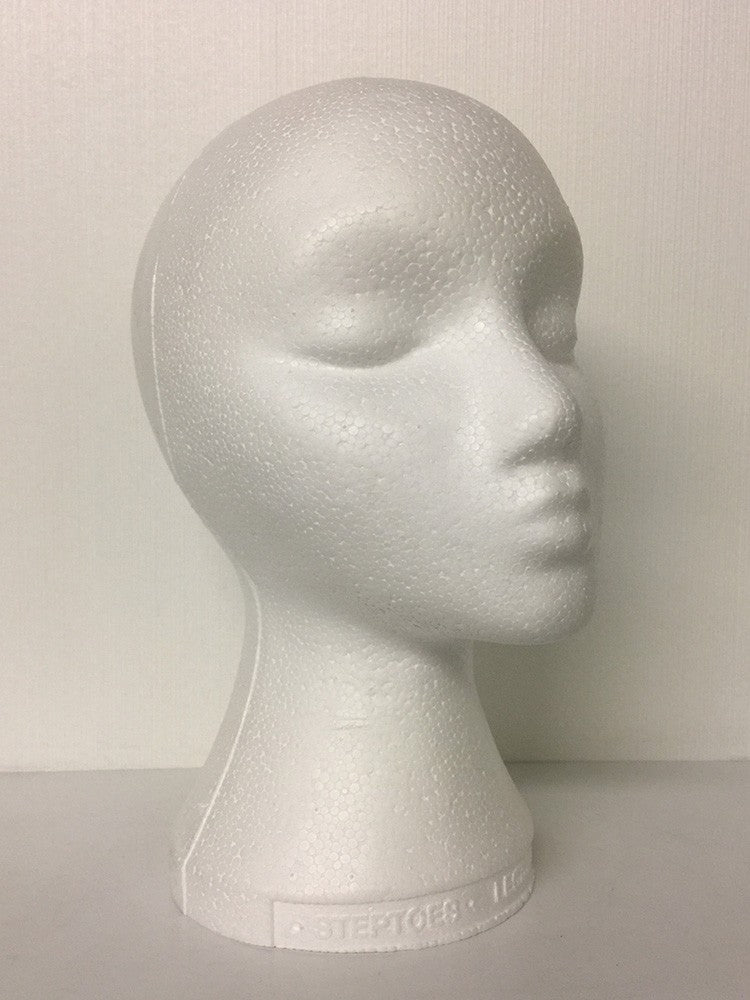 A white styrofoam mannequin head suitable for wigs.