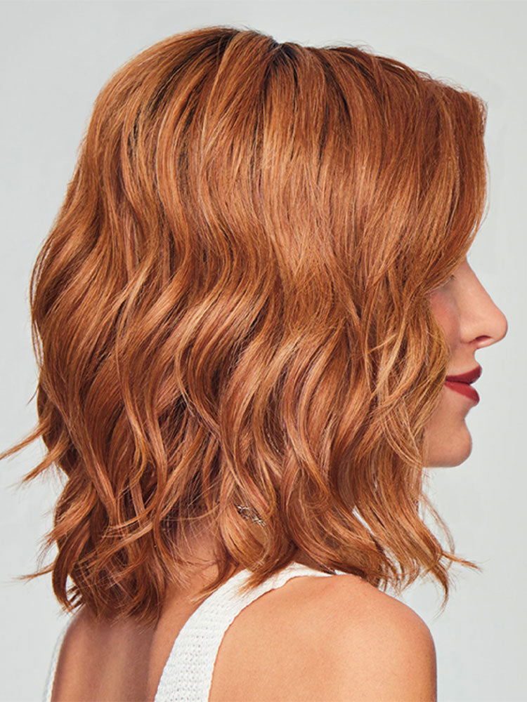 Side view of Simmer Elite wig by Raquel Welch - shoulder-length waves with lace front, mono top and heat-friendly fibre.