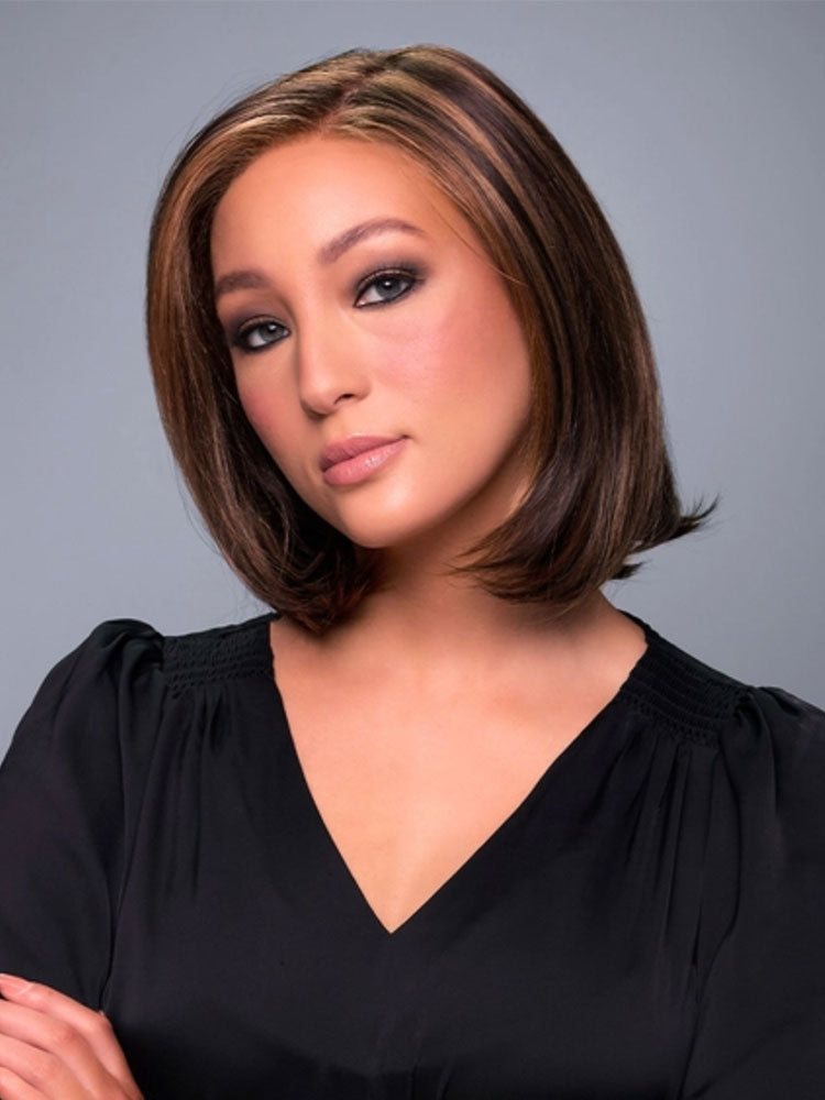 Model wears Cameron Lite wig in Caramel Ribbon 6F27 a chin-length bob with a sleek side part and lace front.