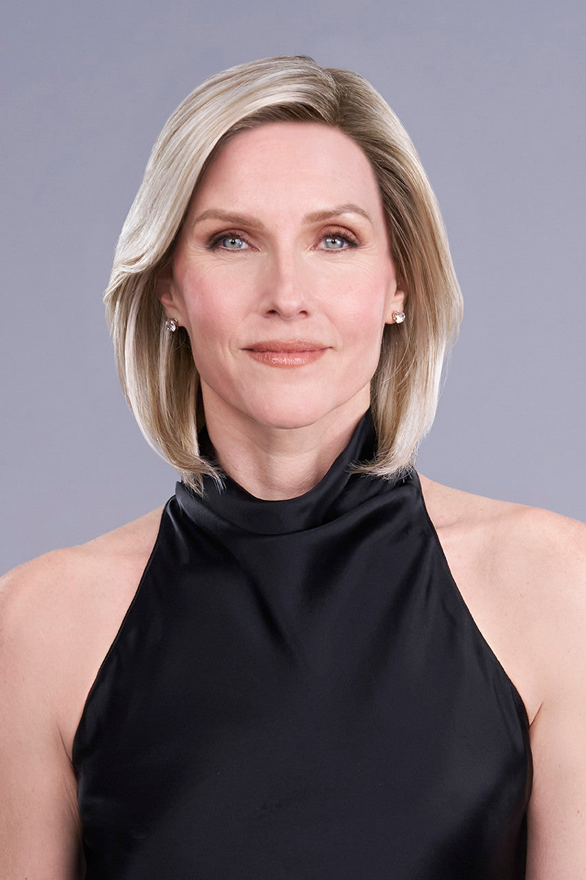 Model wearing Cameron Lite wig in Palm Springs Blonde a chin-length bob with a sleek side part and lace front.