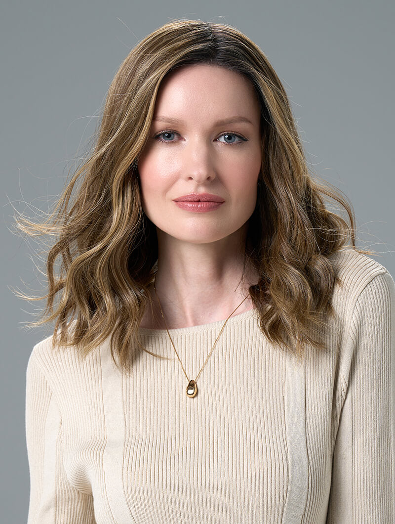 Corey wig with soft waves in Honey Breeze made from heat-friendly EnvyHair and featuring a lace front and monofilament top.