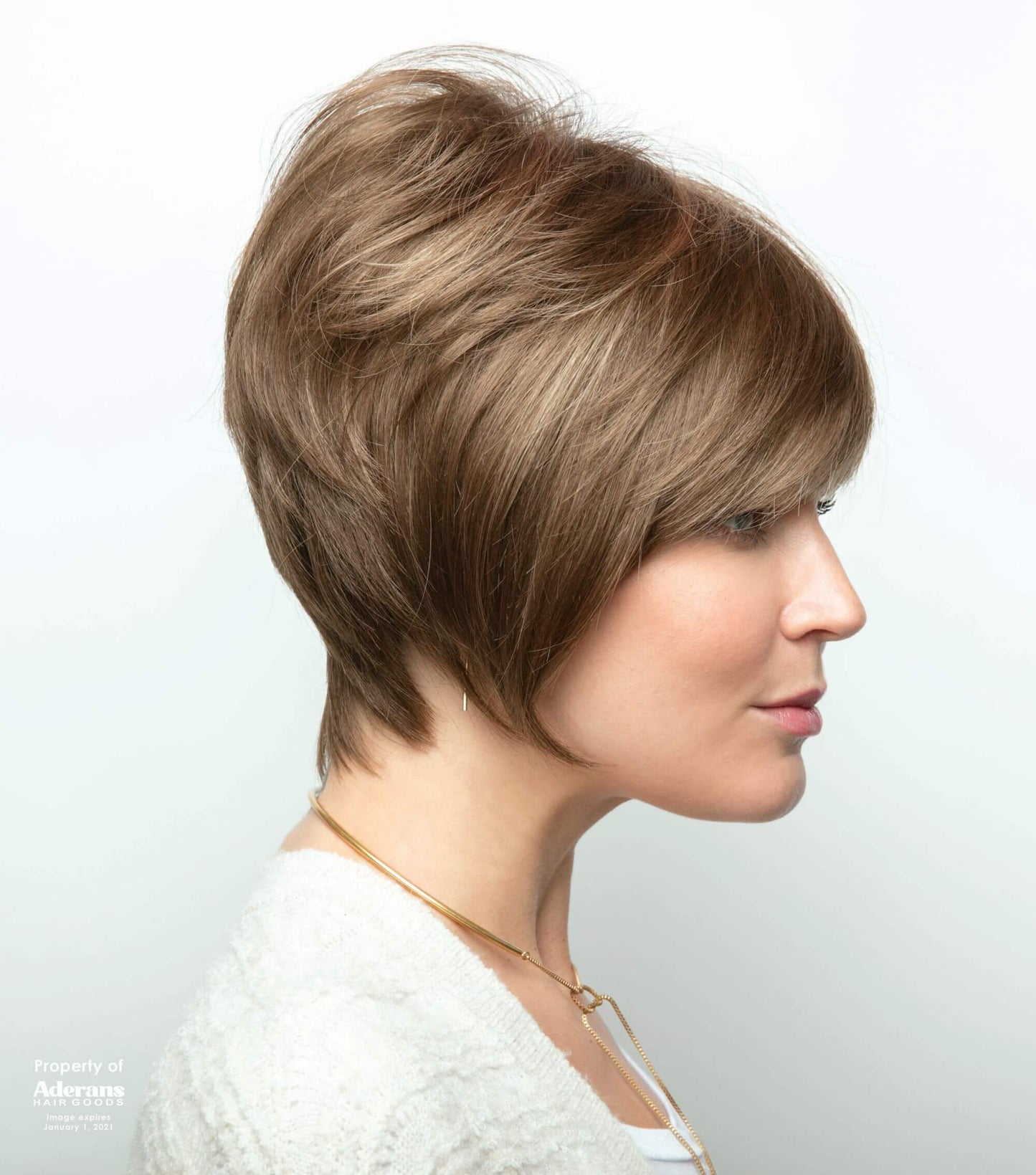 Back view of Emily wig by Amore in Honey Wheat with double monofilament cap is in a wavy short style.