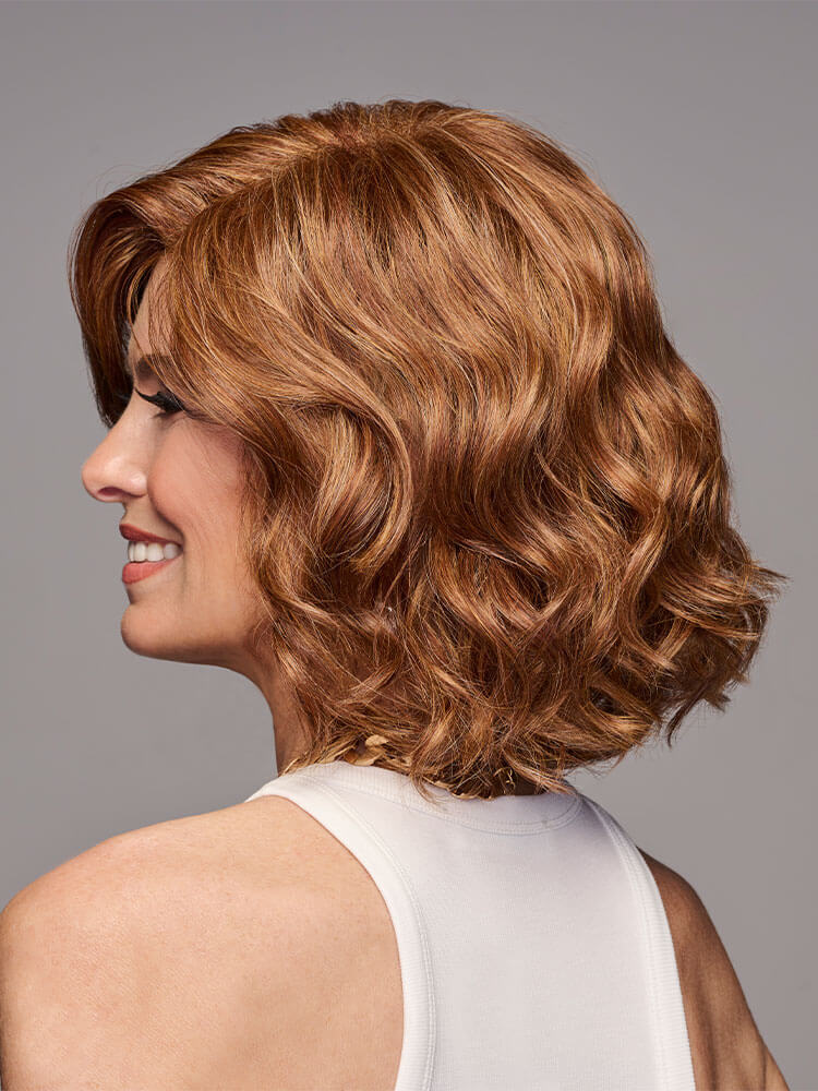 Side profile - In Bloom Wig by Gabor with bouncy curls and heat-friendly synthetic hair in Medium Red.