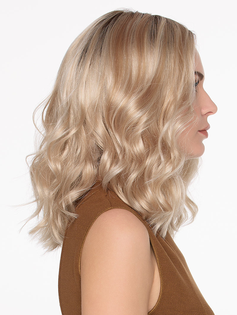 Side view Molly wig by Envy a wavy style with blonde roots, a lace front and mono top