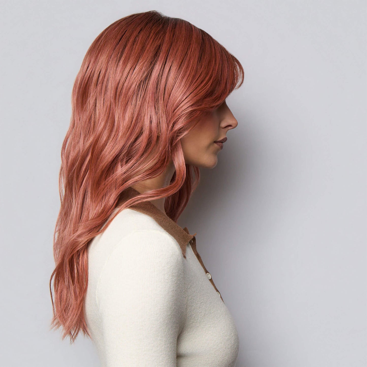 Side profile Long wavy heat resistant synthetic wig with fringe in Dusty Rose-R colour