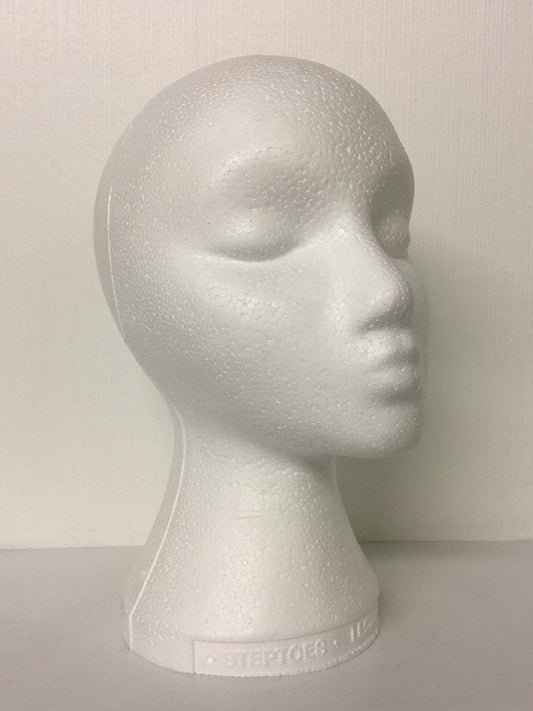 A white styrofoam mannequin head suitable for wigs.